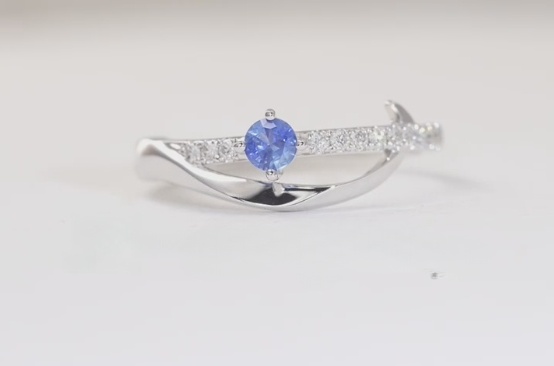 Sketch of a woman's ring with a flowing D, like a river under a crescent moon.