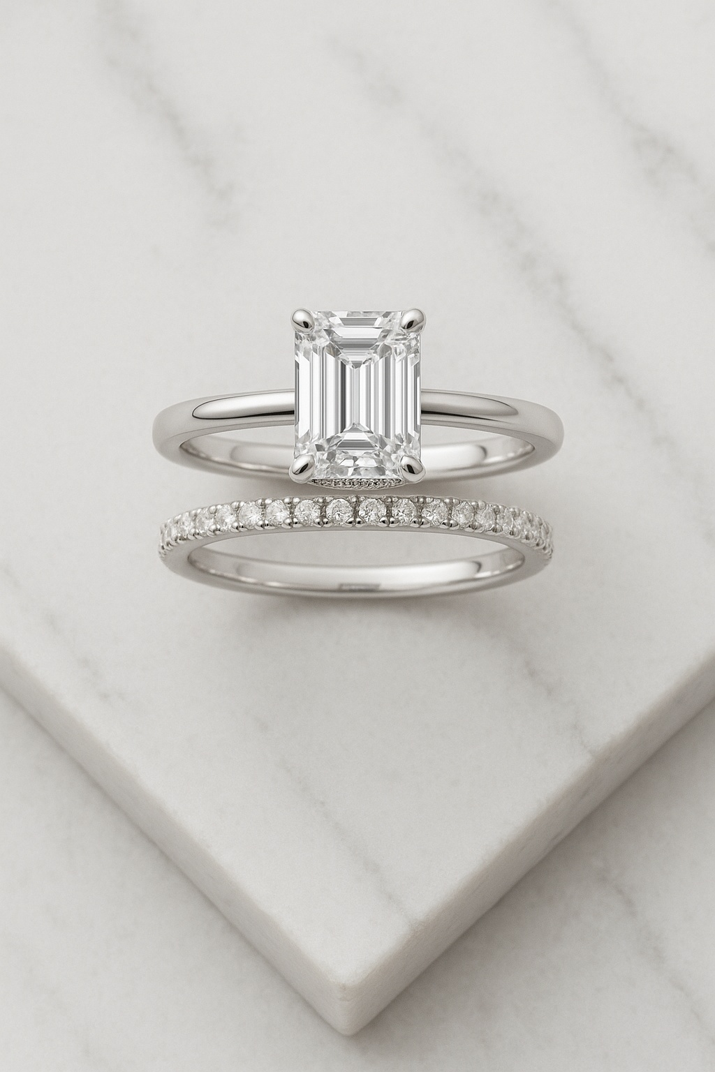 Art-Deco halo around an emerald-cut center with fine milgrain