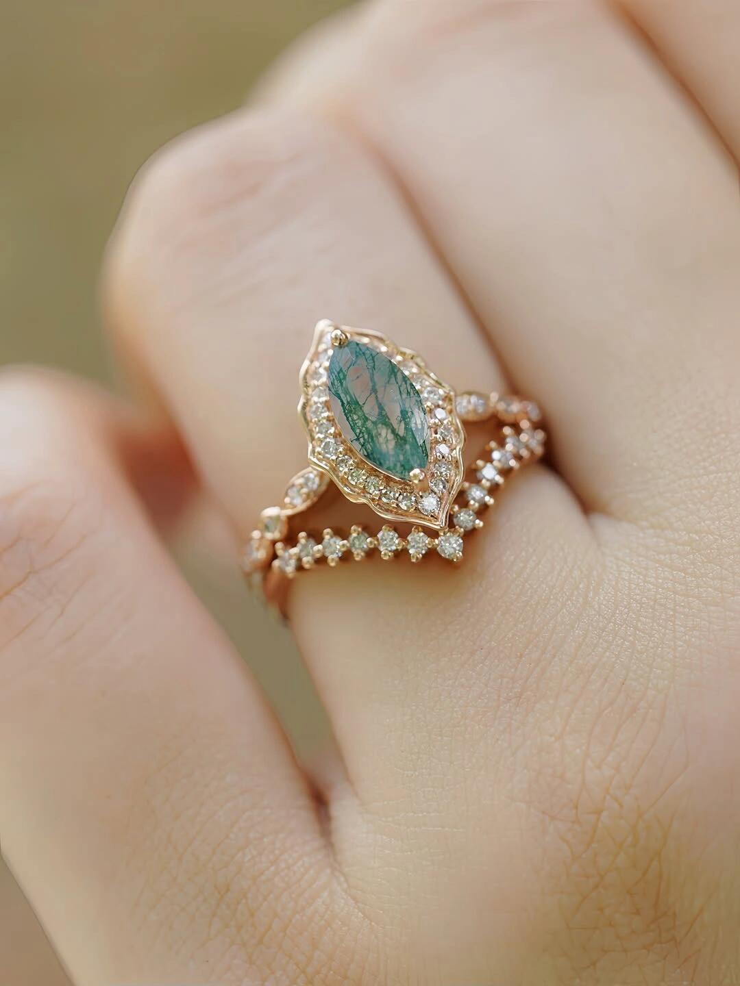 Moss agate ring worn on hand in soft light