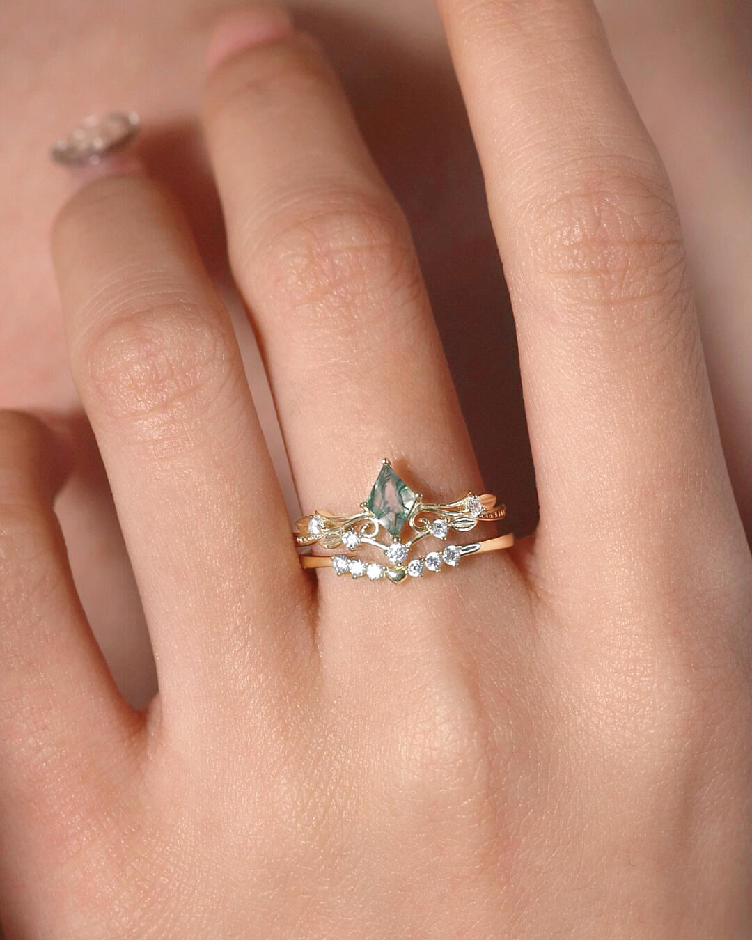 Moss agate engagement ring worn on finger