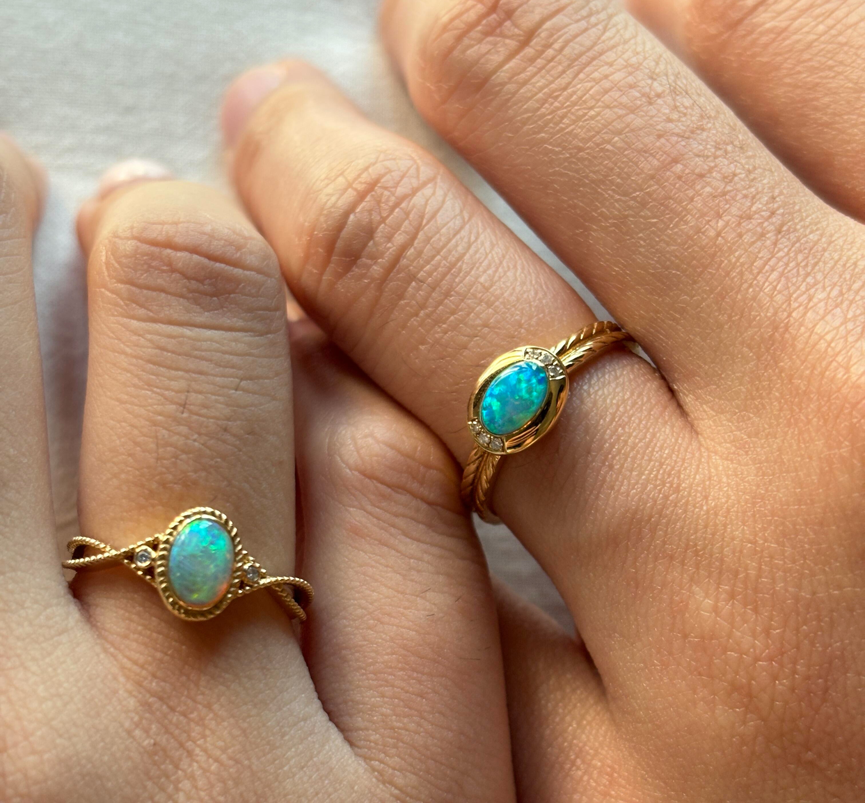 Couple holding hands with opal ring visible